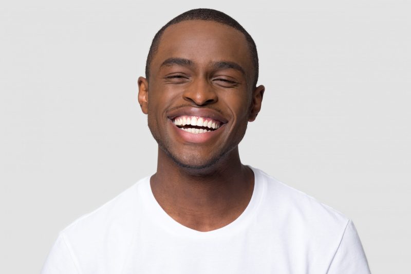 Man smiling after gum whitening procedure