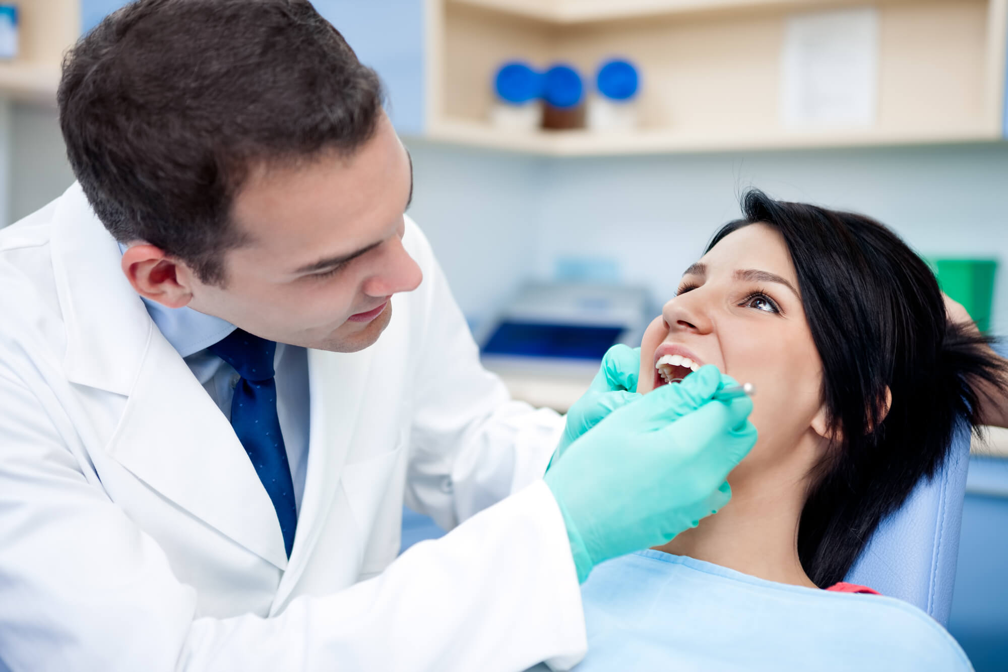 dentist examining patient before receding gums treatment