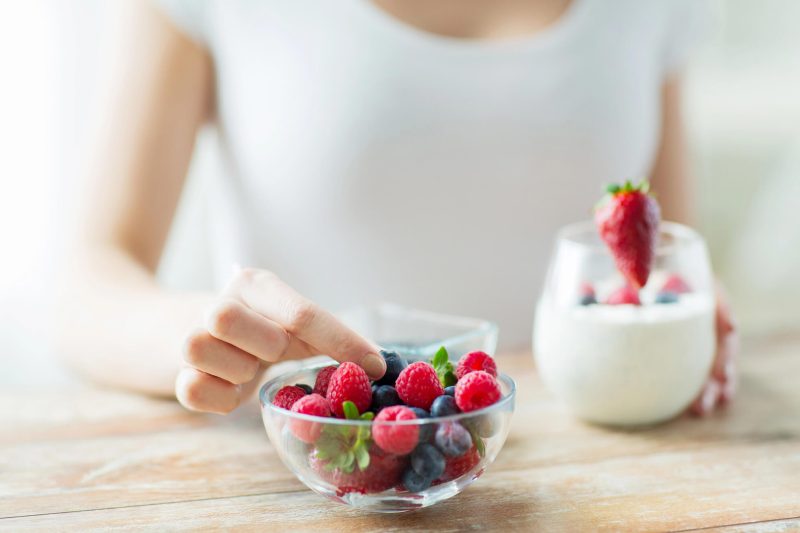 eating-berries-with-Affordable-Dental-Implants