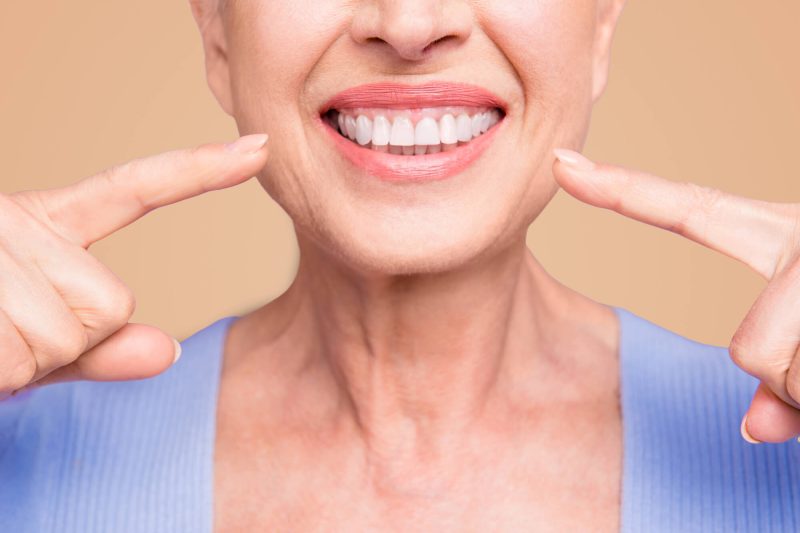 smiling-after-seeing-an-Implant-Dentist